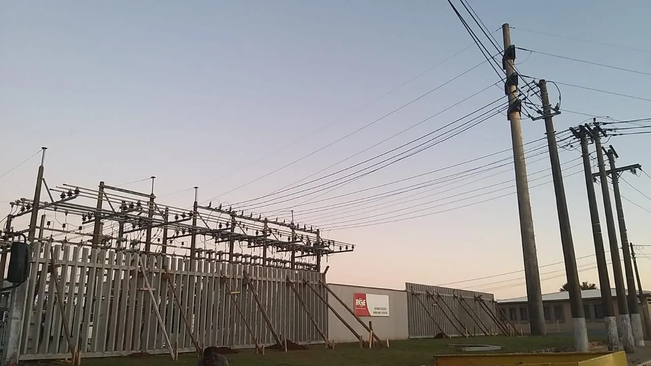 Subestação com muro pré-moldado e postes de rede ao entardecer